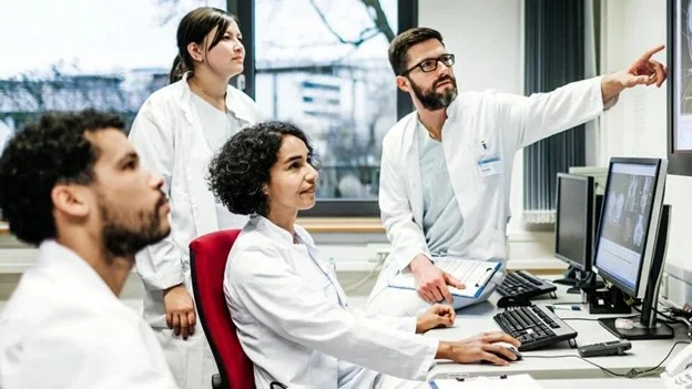 Laboratory colleagues reviewing results together on a computer
